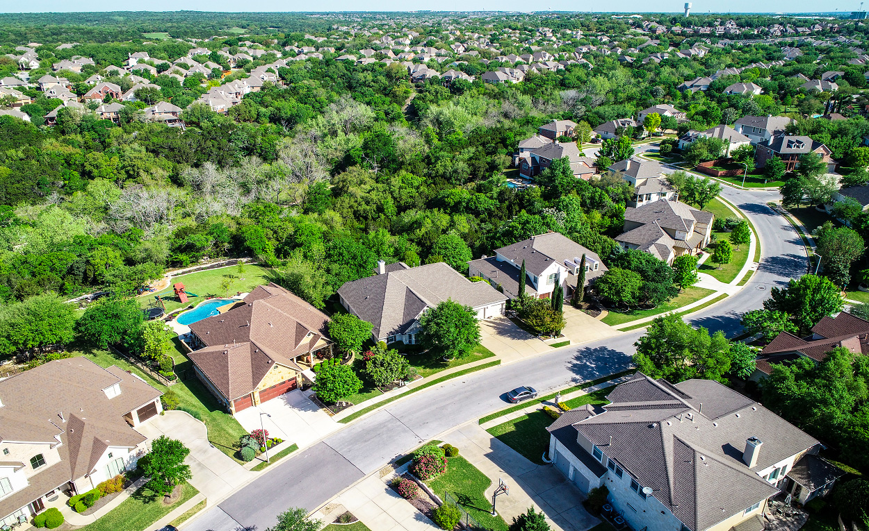 Overhead view of houses on a suburban street.