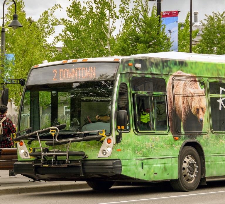 An electric bus wrapped in images of nature