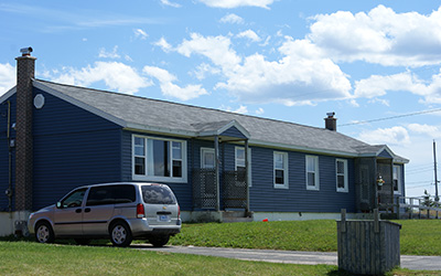 A single-storey home painted deep blue in Pine Tree Park Estates. 