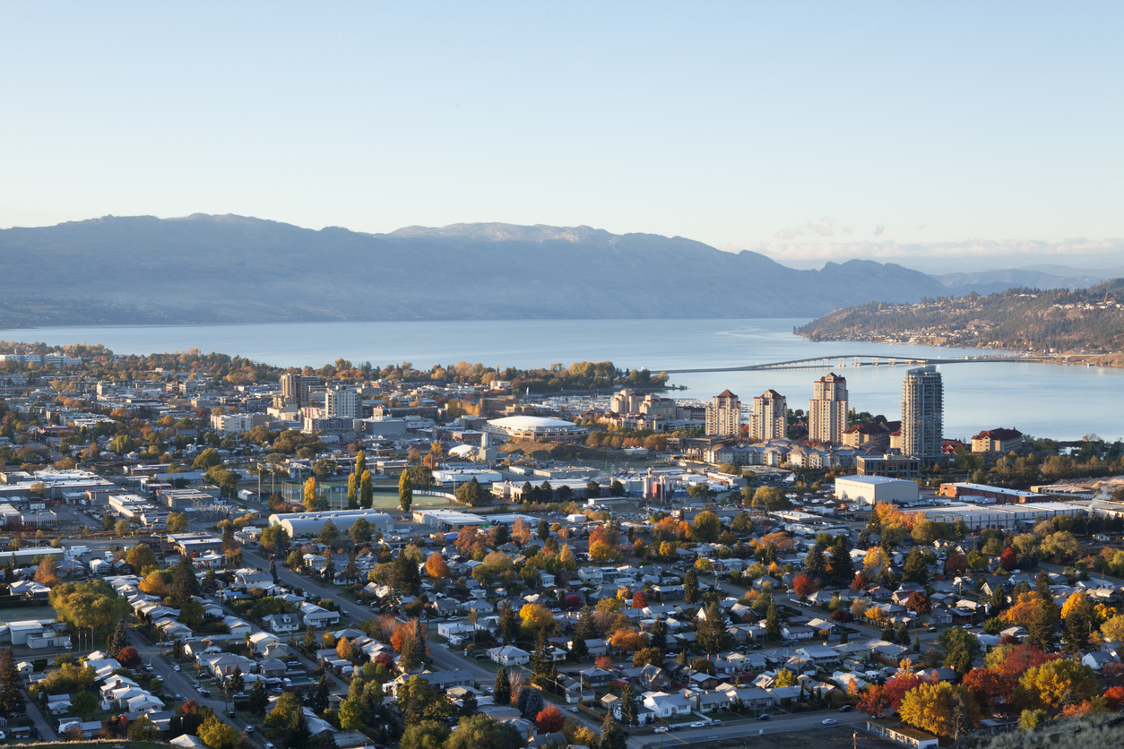 Aeriel view of Kelowna nestled within a valley.