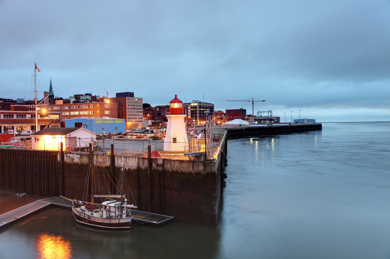 A medium-sized city's harbour at dusk.