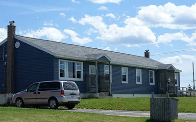 A single-storey home painted deep blue in Pine Tree Park Estates. 
