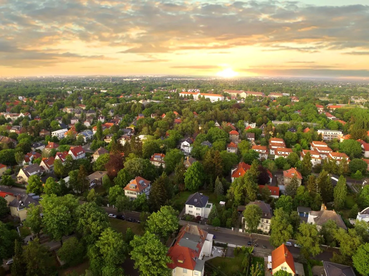aerial view of suburban neighbourhood with houses and trees.