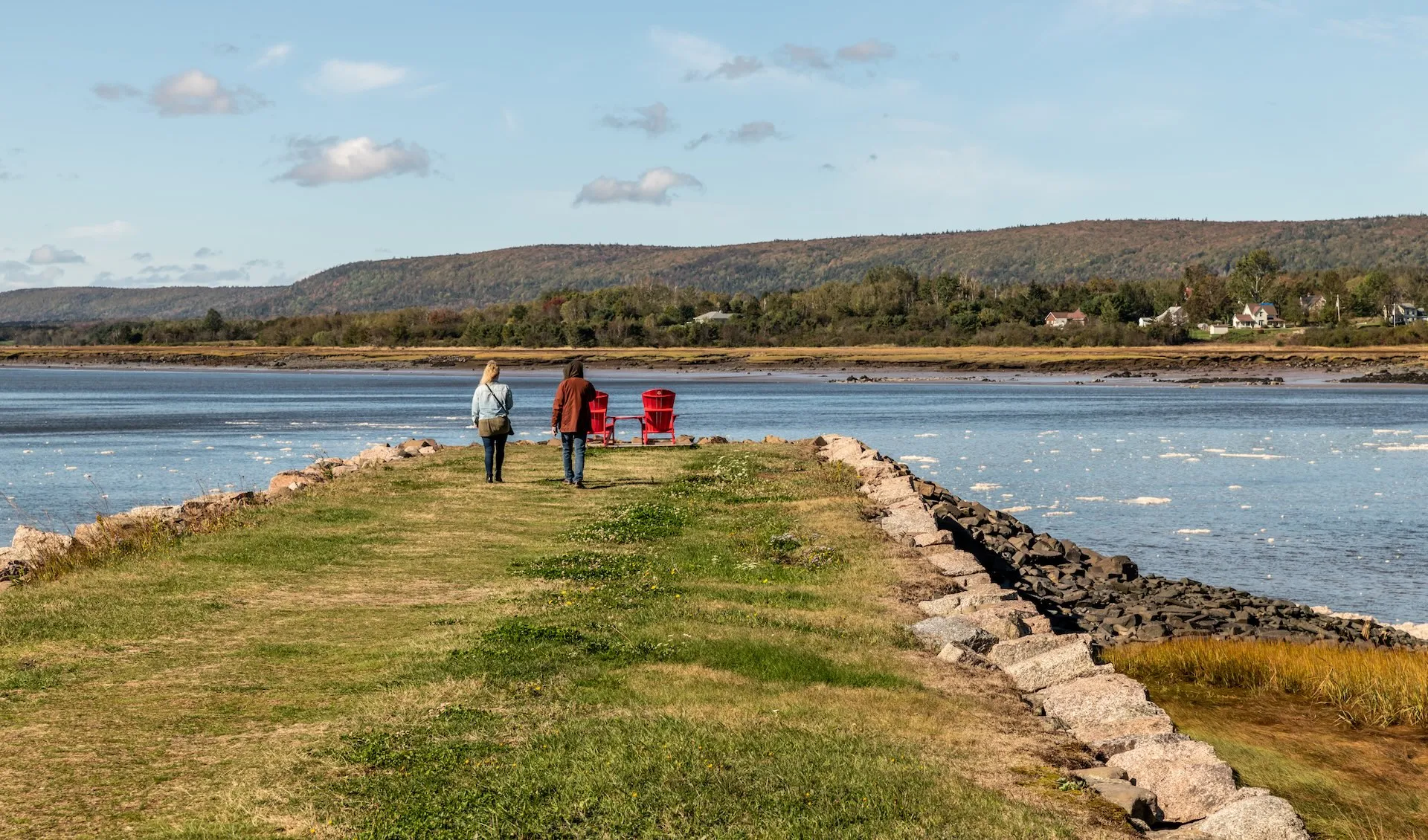 two people walking to deckchairs