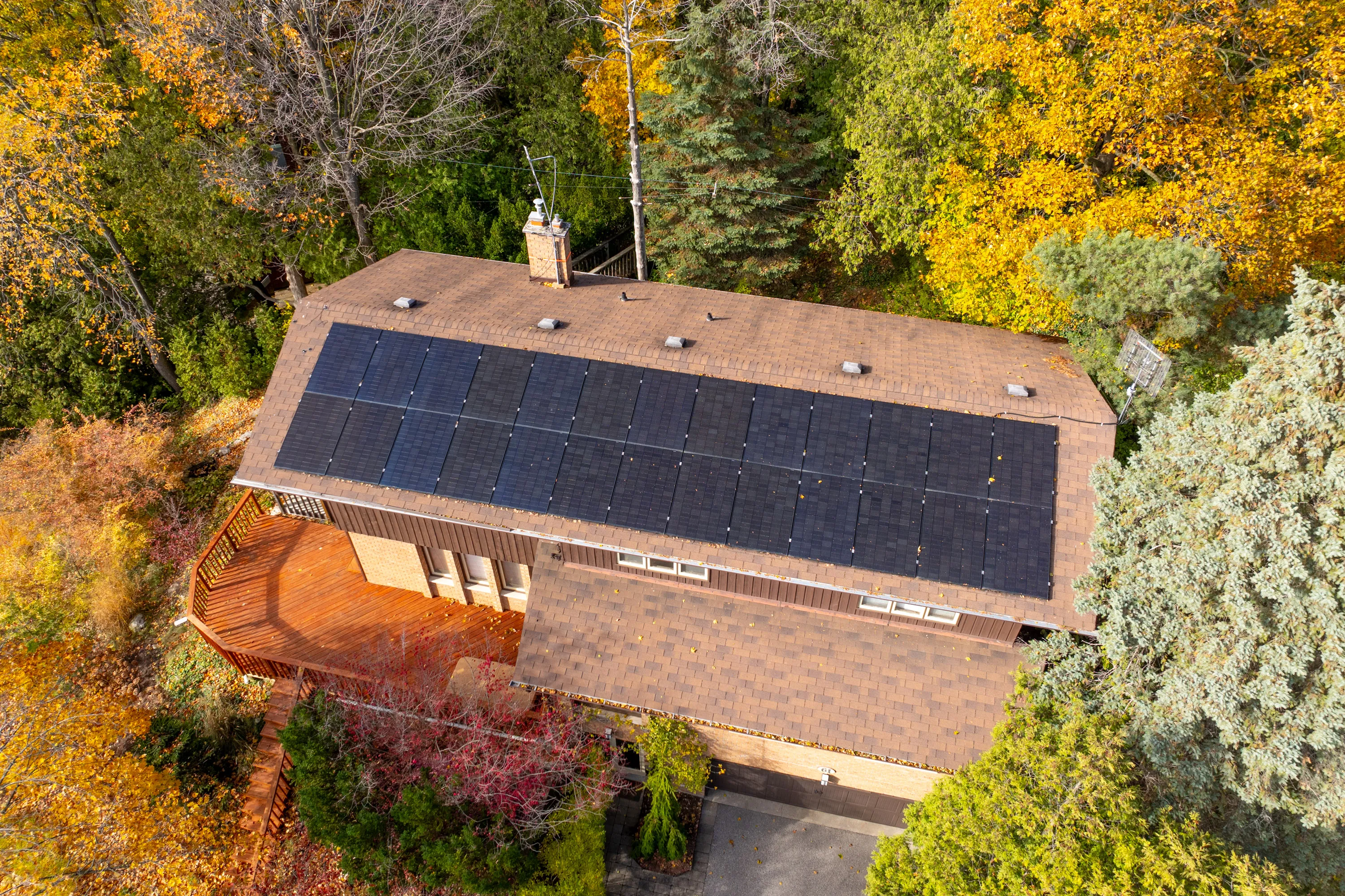 Aerial view of a home with new solar panels on its roof. 