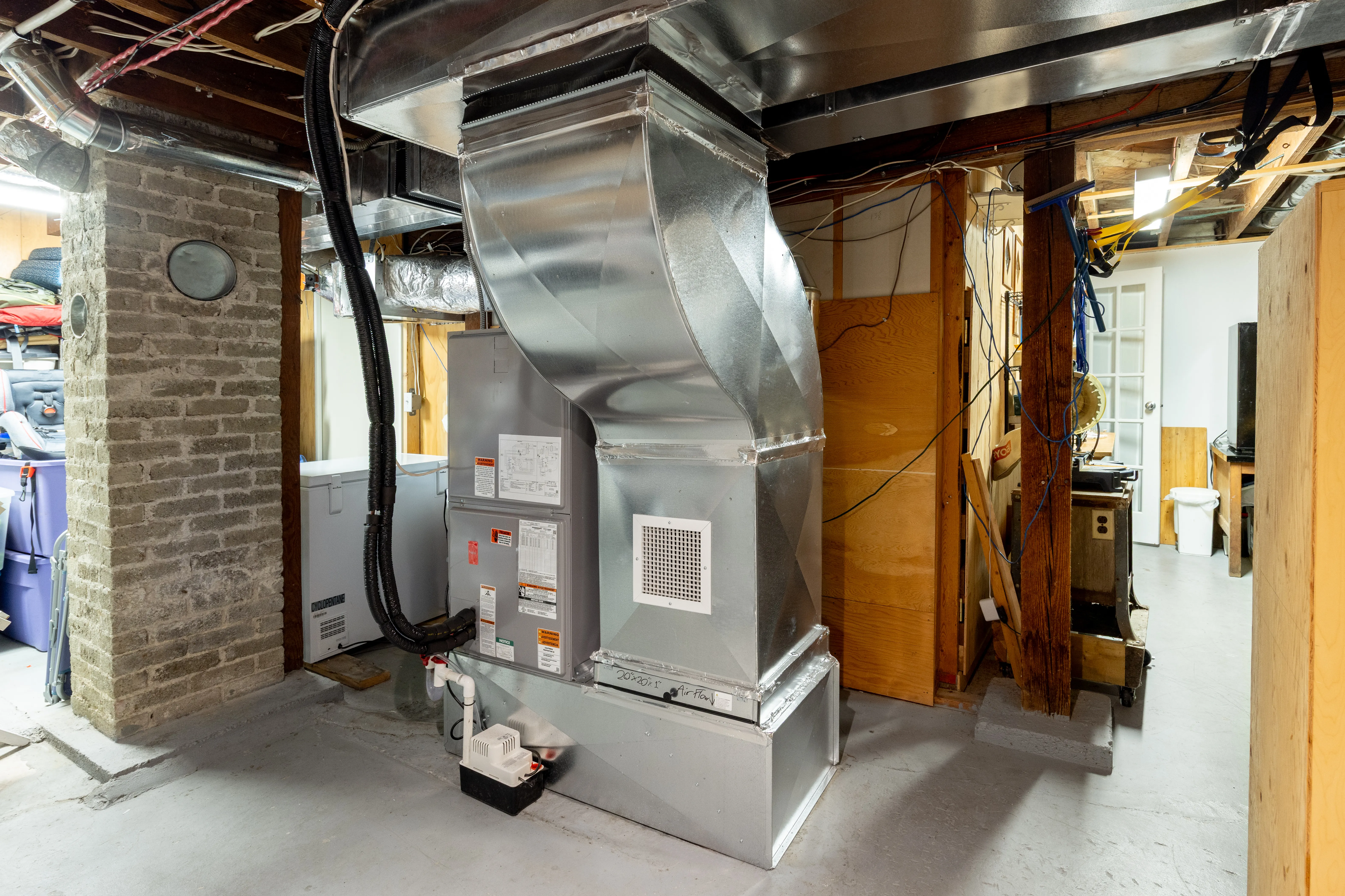 New furnace in an unfinished basement. 