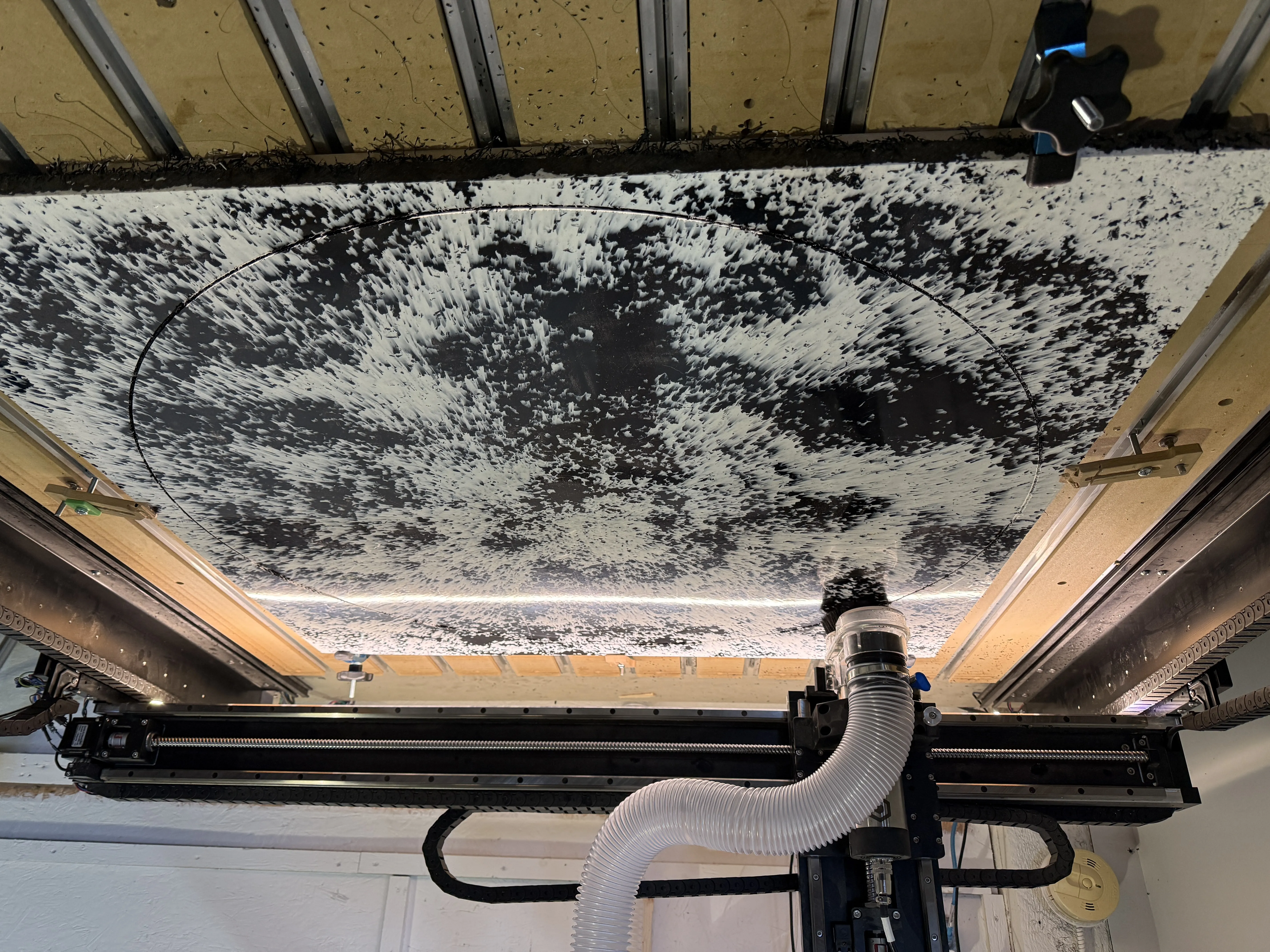 Old grey and black speckled culvert sitting in a workshop setting.